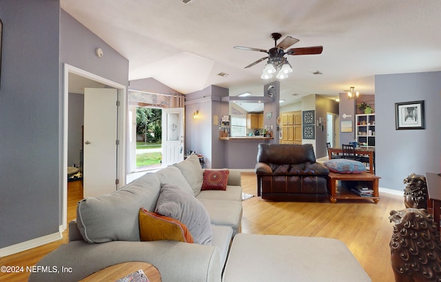 living room with light hardwood / wood-style flooring, lofted ceiling, and ceiling fan