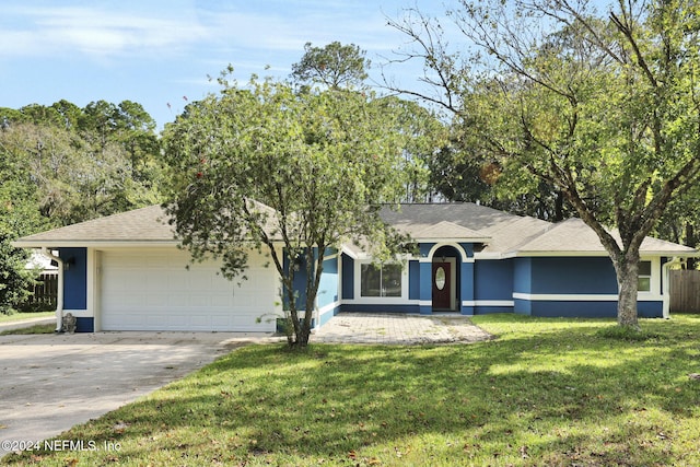 single story home featuring a garage and a front lawn