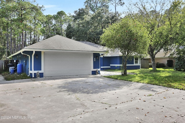 ranch-style house with a garage and a front yard