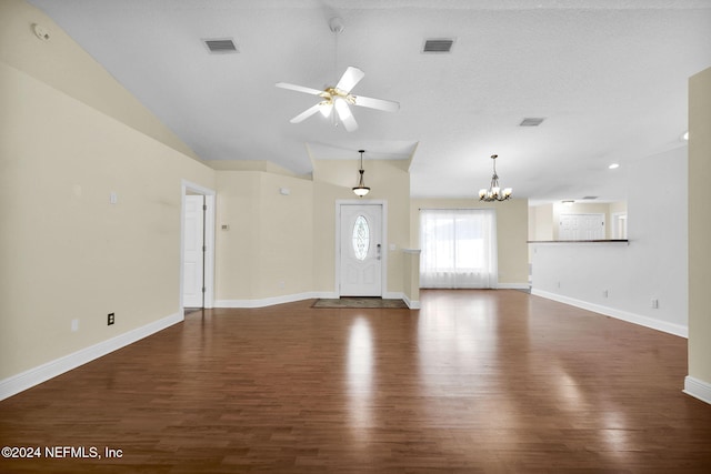 unfurnished living room featuring lofted ceiling, ceiling fan with notable chandelier, and dark wood-type flooring