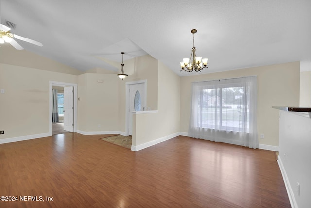 unfurnished living room with lofted ceiling, hardwood / wood-style floors, and ceiling fan with notable chandelier