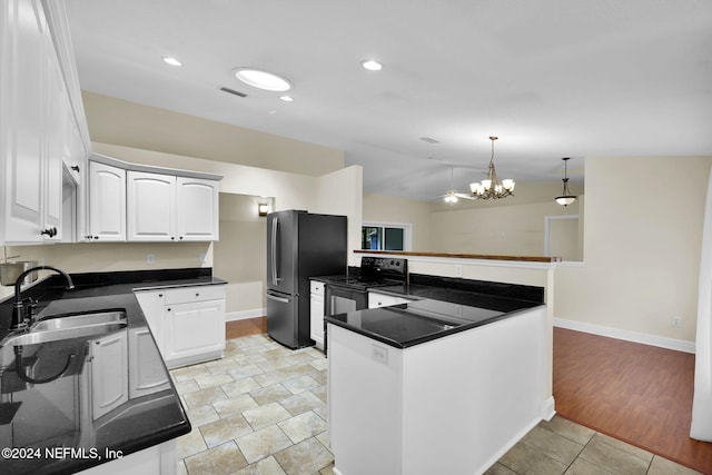 kitchen featuring vaulted ceiling, pendant lighting, white cabinetry, sink, and kitchen peninsula