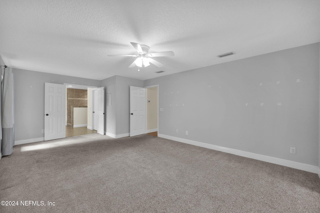 unfurnished bedroom featuring ceiling fan, a textured ceiling, and carpet flooring