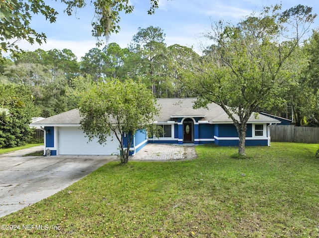 ranch-style house with a garage and a front lawn