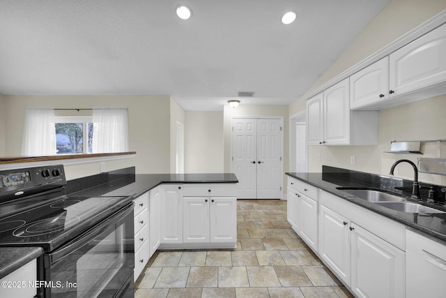 kitchen featuring white cabinetry, black range with electric stovetop, sink, and kitchen peninsula