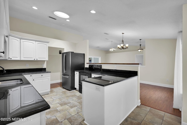 kitchen featuring sink, white cabinetry, kitchen peninsula, black range with electric cooktop, and pendant lighting