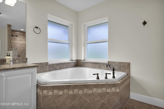 bathroom with tile patterned floors, shower with separate bathtub, and vanity