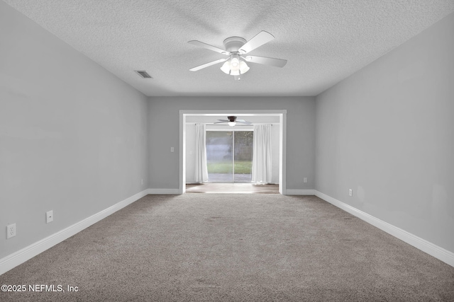 carpeted empty room with ceiling fan and a textured ceiling