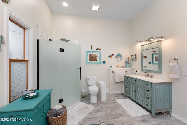 bathroom with vanity, toilet, and a shower