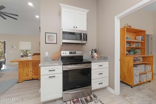 408 Third St, Saint Augustine, FL 32084 - kitchen with appliances with stainless steel finishes, ceiling fan, light countertops, white cabinets, and light wood-style floors