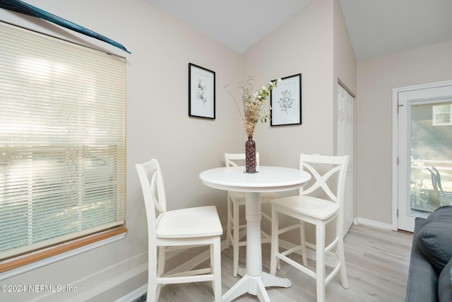 408 Third St, Saint Augustine, FL 32084 - dining room with light wood finished floors and lofted ceiling