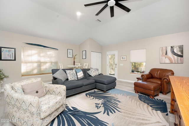 living room featuring ceiling fan, vaulted ceiling, and hardwood / wood-style flooring