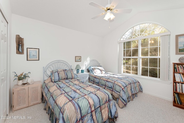 carpeted bedroom featuring a closet, ceiling fan, and lofted ceiling