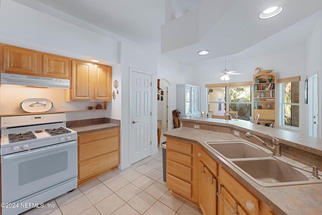408 Third St, Saint Augustine, FL 32084 - kitchen featuring white gas stove, under cabinet range hood, light brown cabinets, ceiling fan, and light tile patterned floors