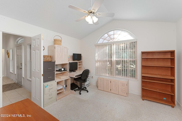 carpeted office space with ceiling fan and lofted ceiling