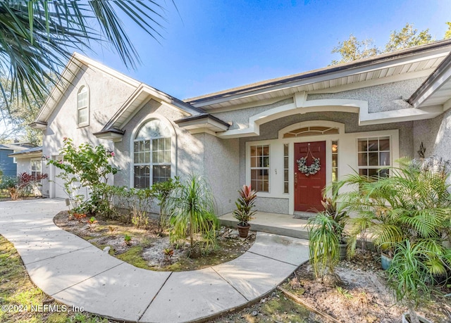 view of exterior entry with a garage