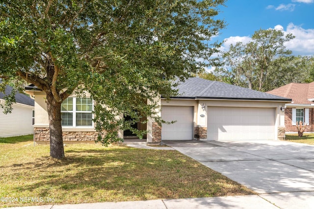 view of front of home with a garage and a front lawn