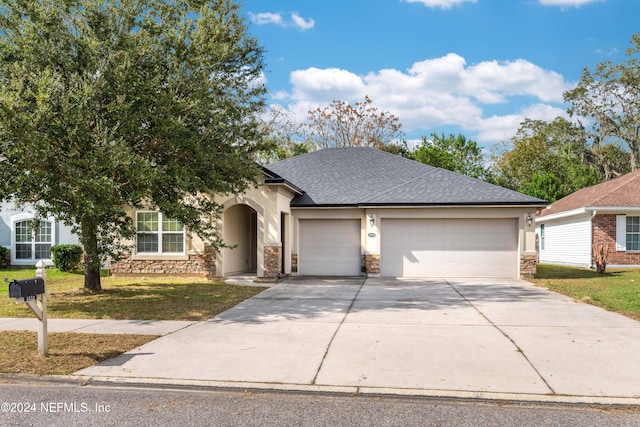 view of front facade with a garage and a front lawn