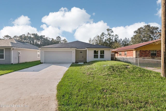 ranch-style home featuring a front lawn and a garage