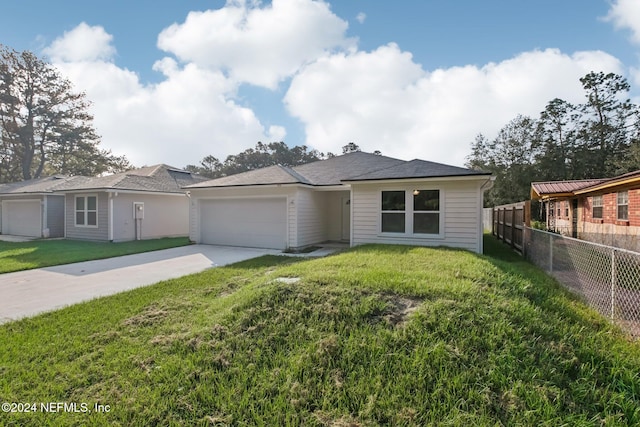 ranch-style house with a garage and a front lawn