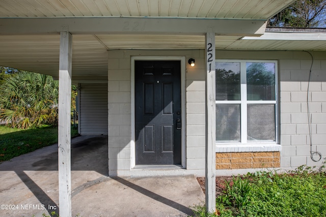 view of exterior entry featuring a porch