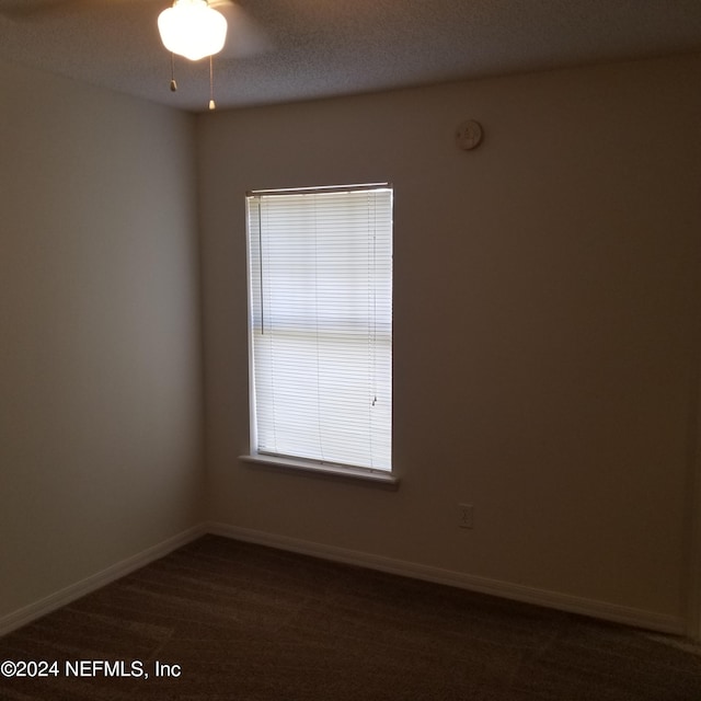 empty room with dark colored carpet