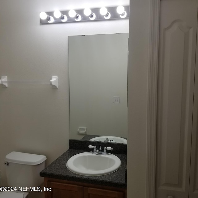 bathroom with toilet and vanity