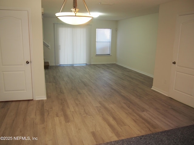 unfurnished room with hardwood / wood-style flooring