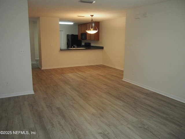 unfurnished living room with dark hardwood / wood-style floors