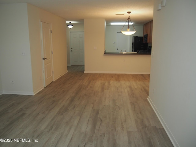 interior space with light hardwood / wood-style floors and sink