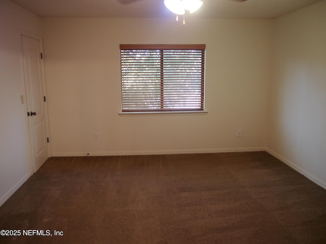 carpeted spare room featuring ceiling fan