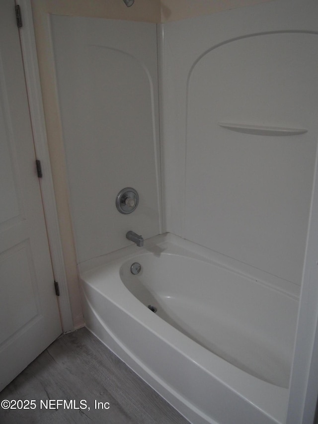 bathroom featuring tub / shower combination and hardwood / wood-style floors