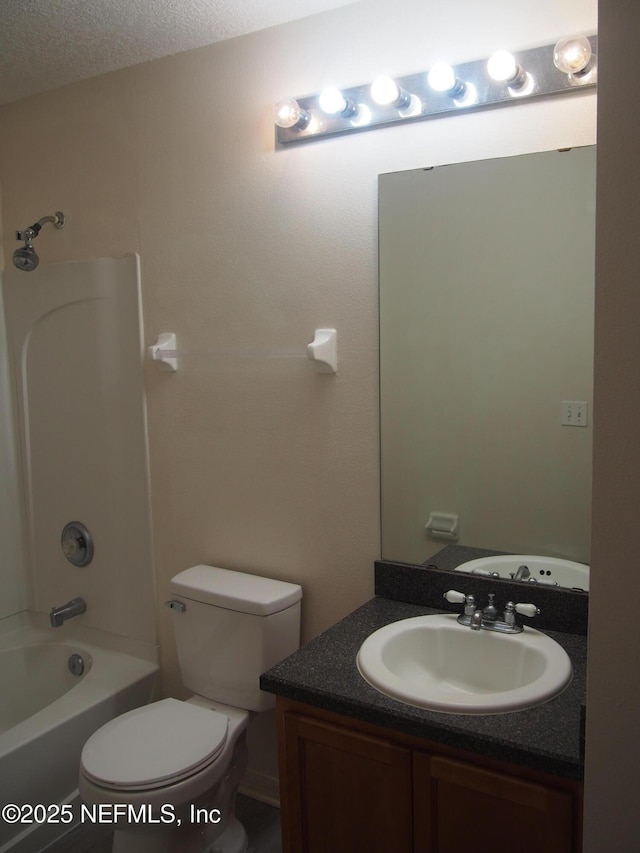 full bathroom featuring a textured ceiling, toilet, vanity, and bathing tub / shower combination