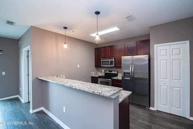 kitchen with kitchen peninsula, dark hardwood / wood-style floors, pendant lighting, and appliances with stainless steel finishes