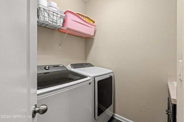 clothes washing area with washing machine and dryer