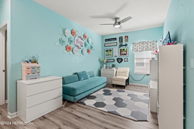 living area featuring ceiling fan and light wood-type flooring