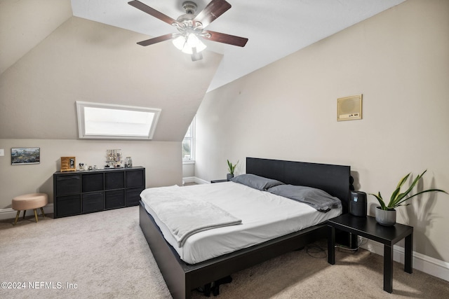 carpeted bedroom featuring ceiling fan and vaulted ceiling