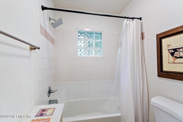 bathroom with shower / bath combo and toilet