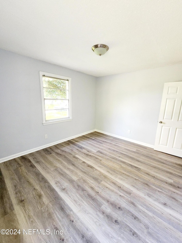 unfurnished room with light hardwood / wood-style flooring