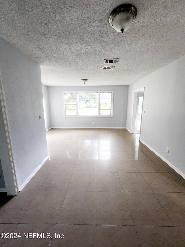 3505 Shadow St, Jacksonville, FL 32254 - tiled spare room with baseboards and a textured ceiling