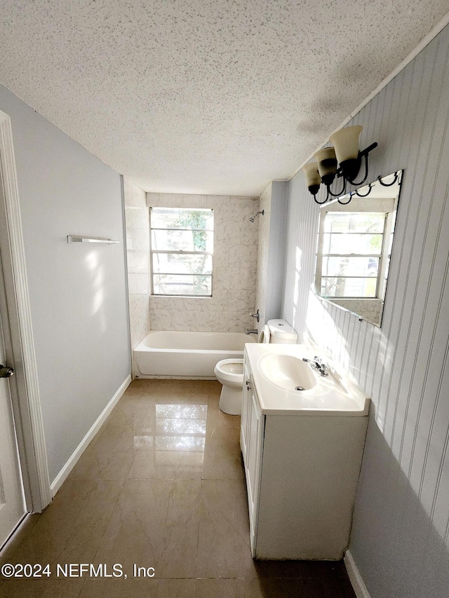 full bathroom featuring plenty of natural light, vanity, a textured ceiling, and toilet