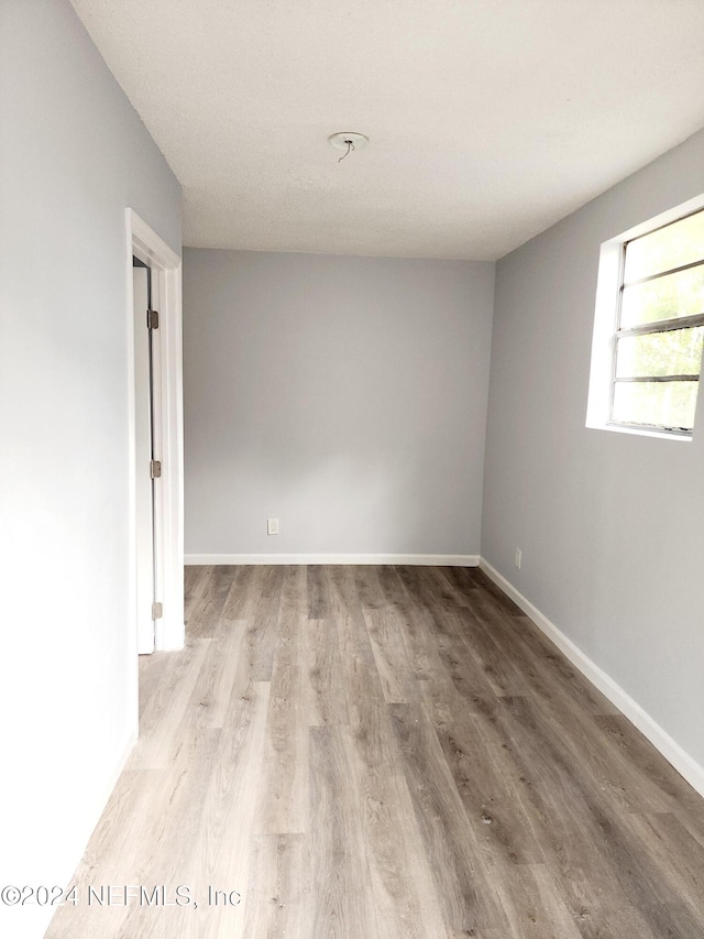 spare room with light wood-type flooring