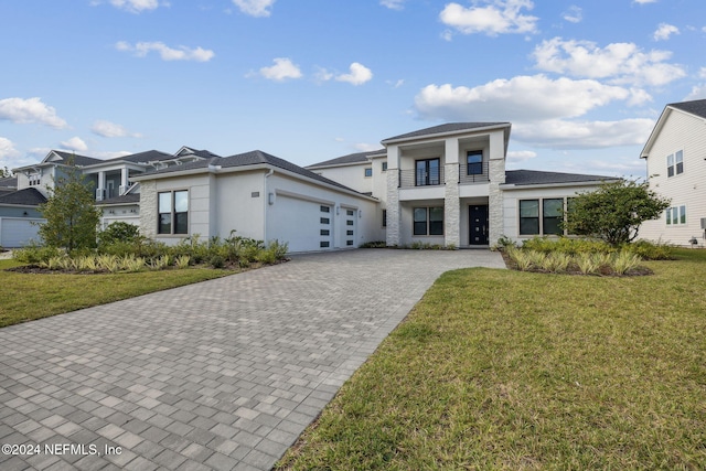 view of front of home with a balcony and a front yard