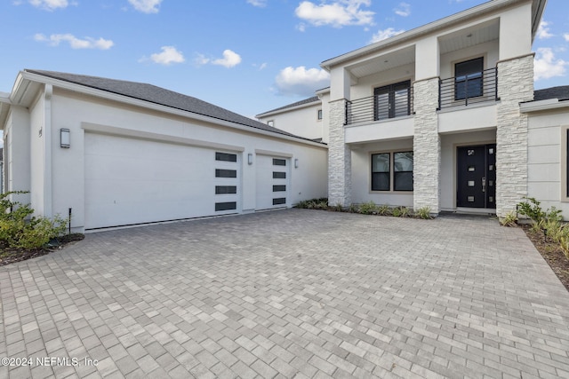 contemporary house featuring a balcony and a garage