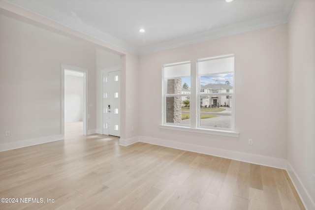 spare room with light hardwood / wood-style flooring and ornamental molding