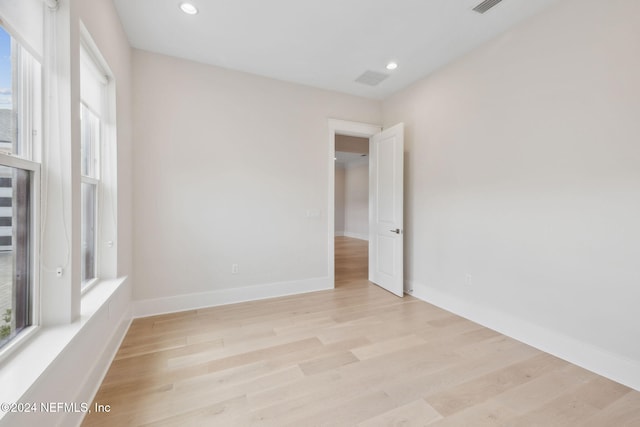 unfurnished room with light hardwood / wood-style flooring