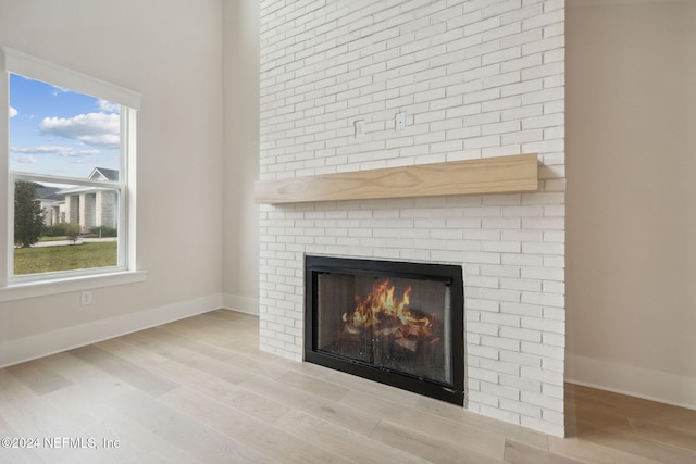 details featuring wood-type flooring and a brick fireplace