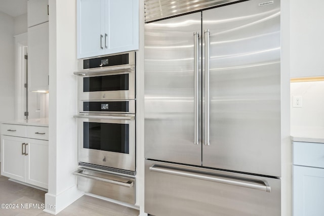 kitchen featuring white cabinets and appliances with stainless steel finishes