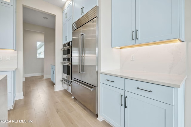 kitchen featuring light wood-type flooring and appliances with stainless steel finishes