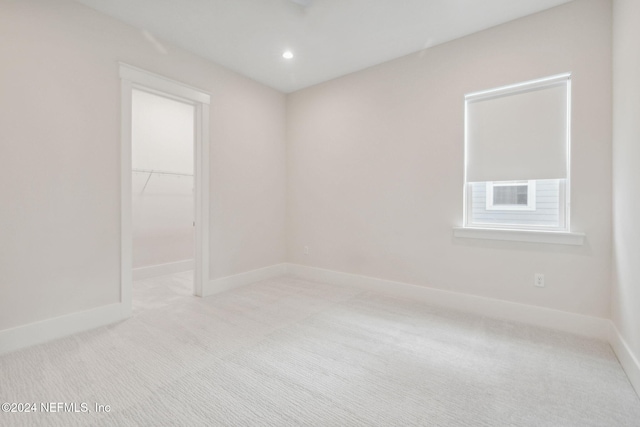 spare room featuring light colored carpet